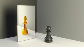 Chess pawn in a mirror reflecting himself as a king